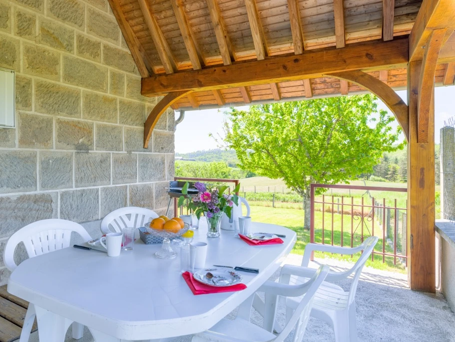 Salon de jardin  à l'entrée du gîte sous l'auvent