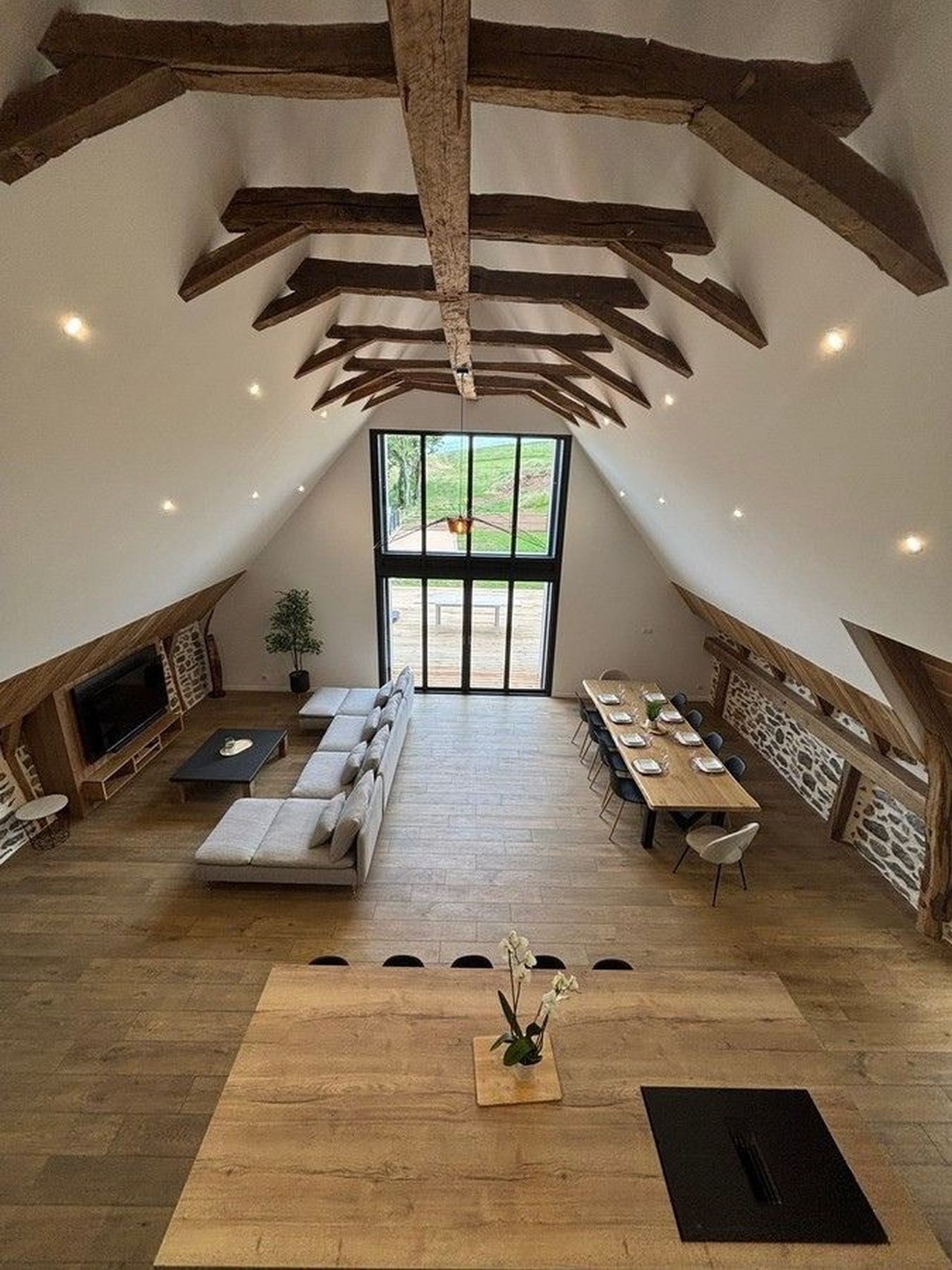 View of the living room, lounge and open-plan kitchen with floor-to-ceiling windows