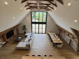 View of the living room, lounge and open-plan kitchen with floor-to-ceiling windows