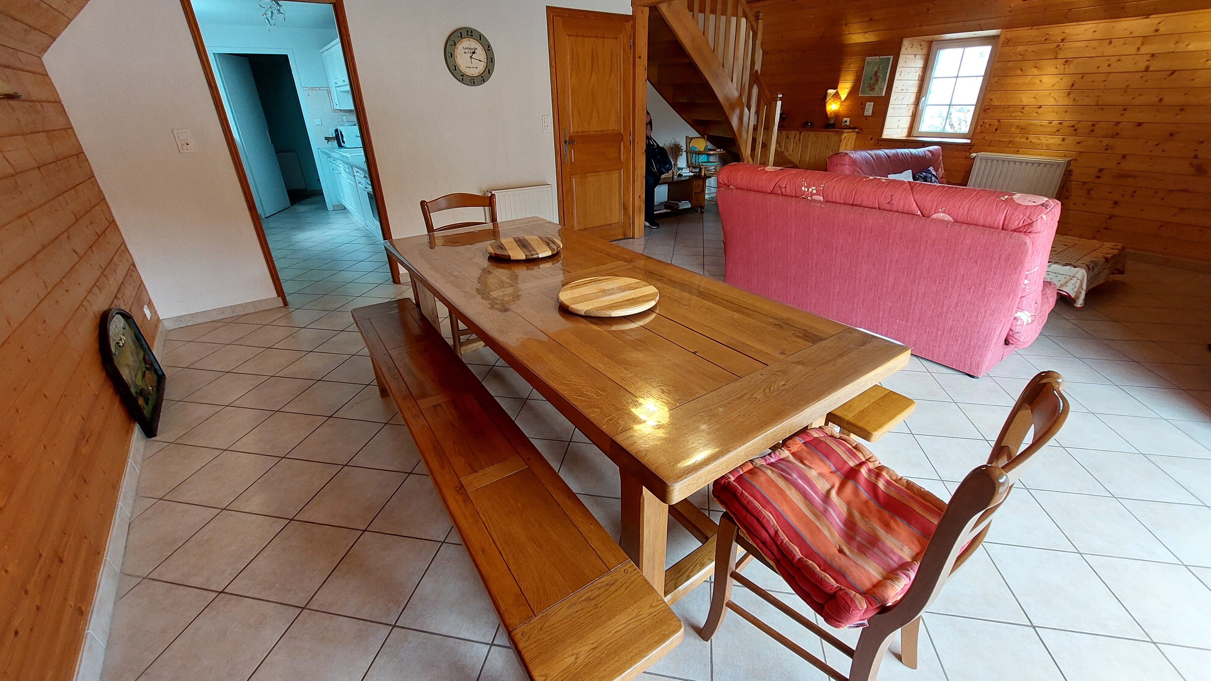 Dining room with large wooden table for convivial family meals in the Cantal