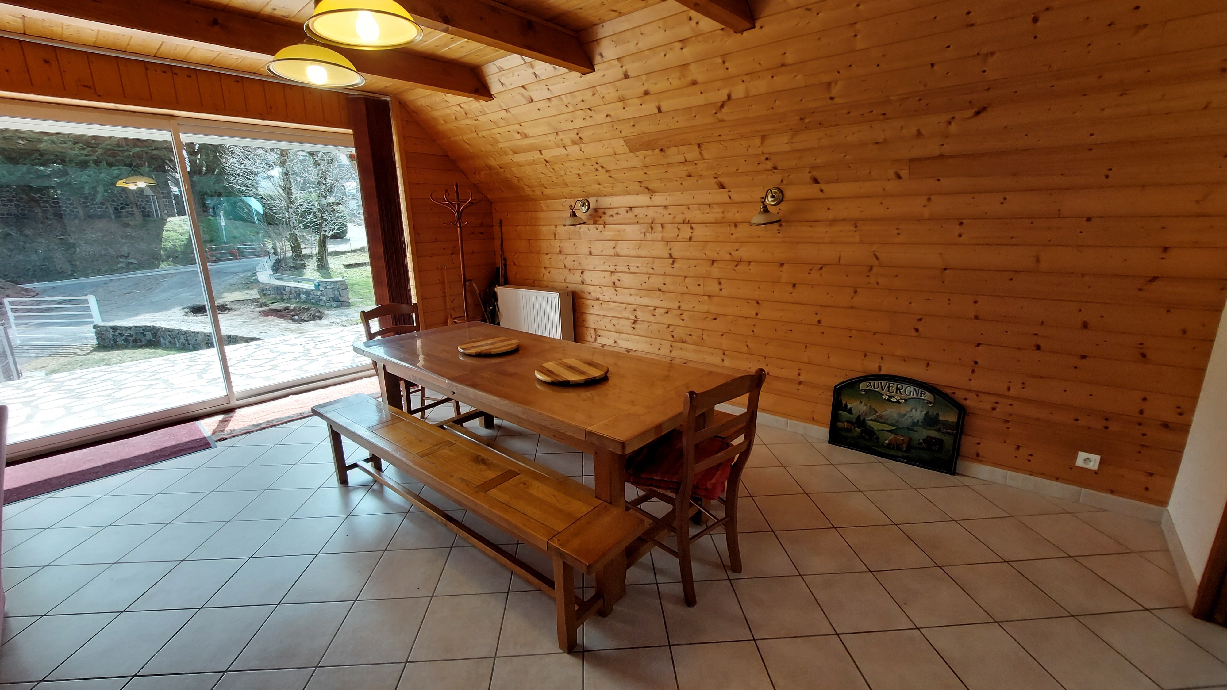 Detail of solid wood table with bench for a group meal in an Auvergne gîte