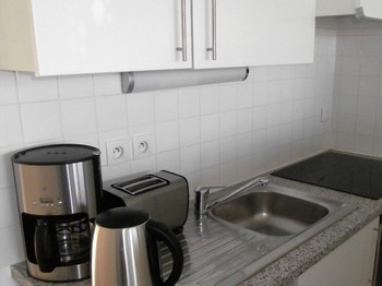 le coin cuisine avec plaque à induction et four électrique