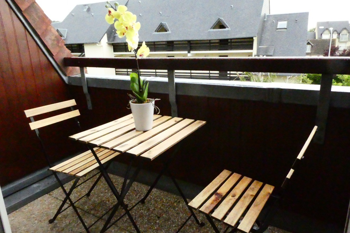 une table et 2 chaise sur le balcon, possibilité de mettre un parasol