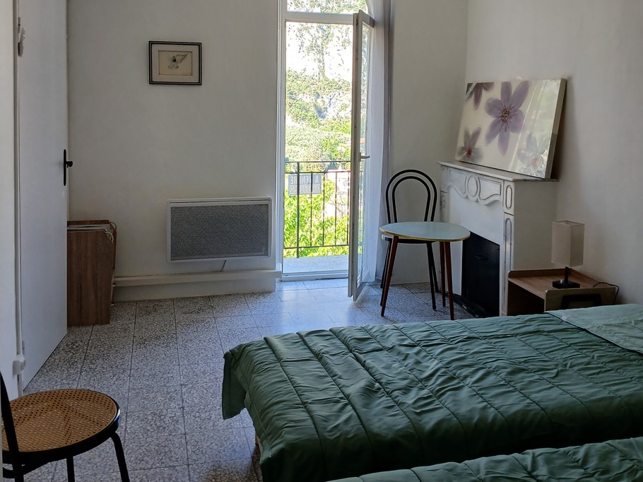 The bedroom with access to the balcony