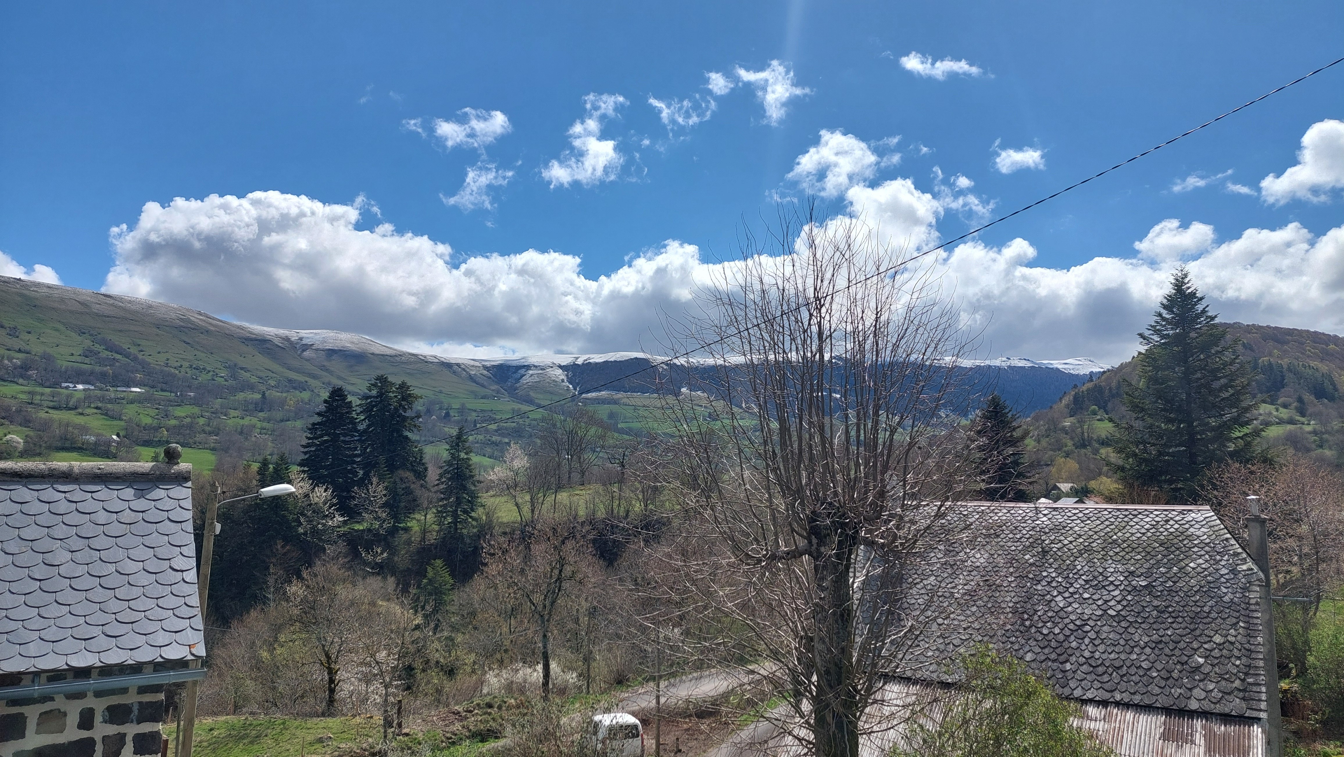 View of the Cantal mountains with garden and green landscape