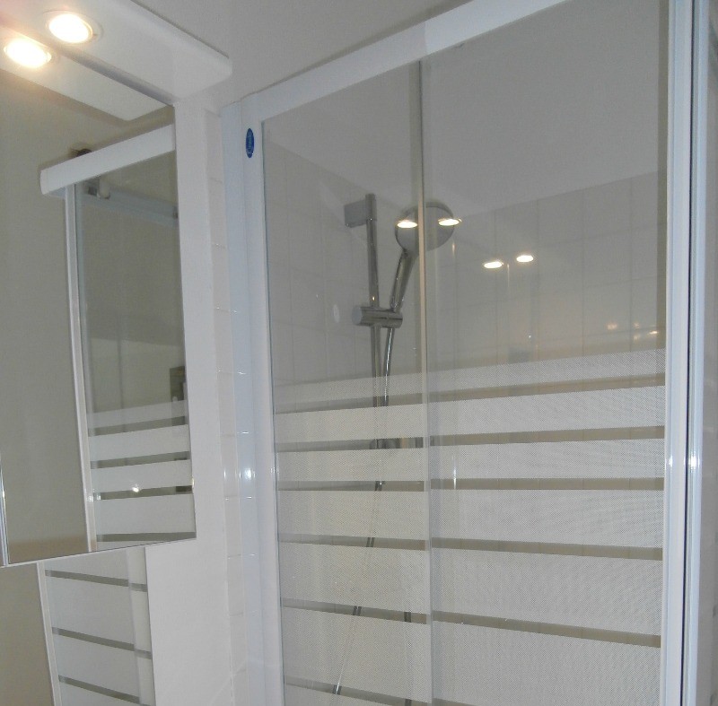 the bathroom with its shower and storage space