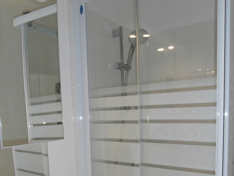 the bathroom with its shower and storage space