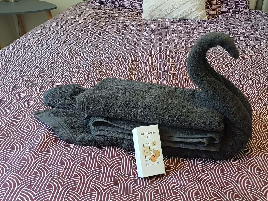 At the foot of the bed