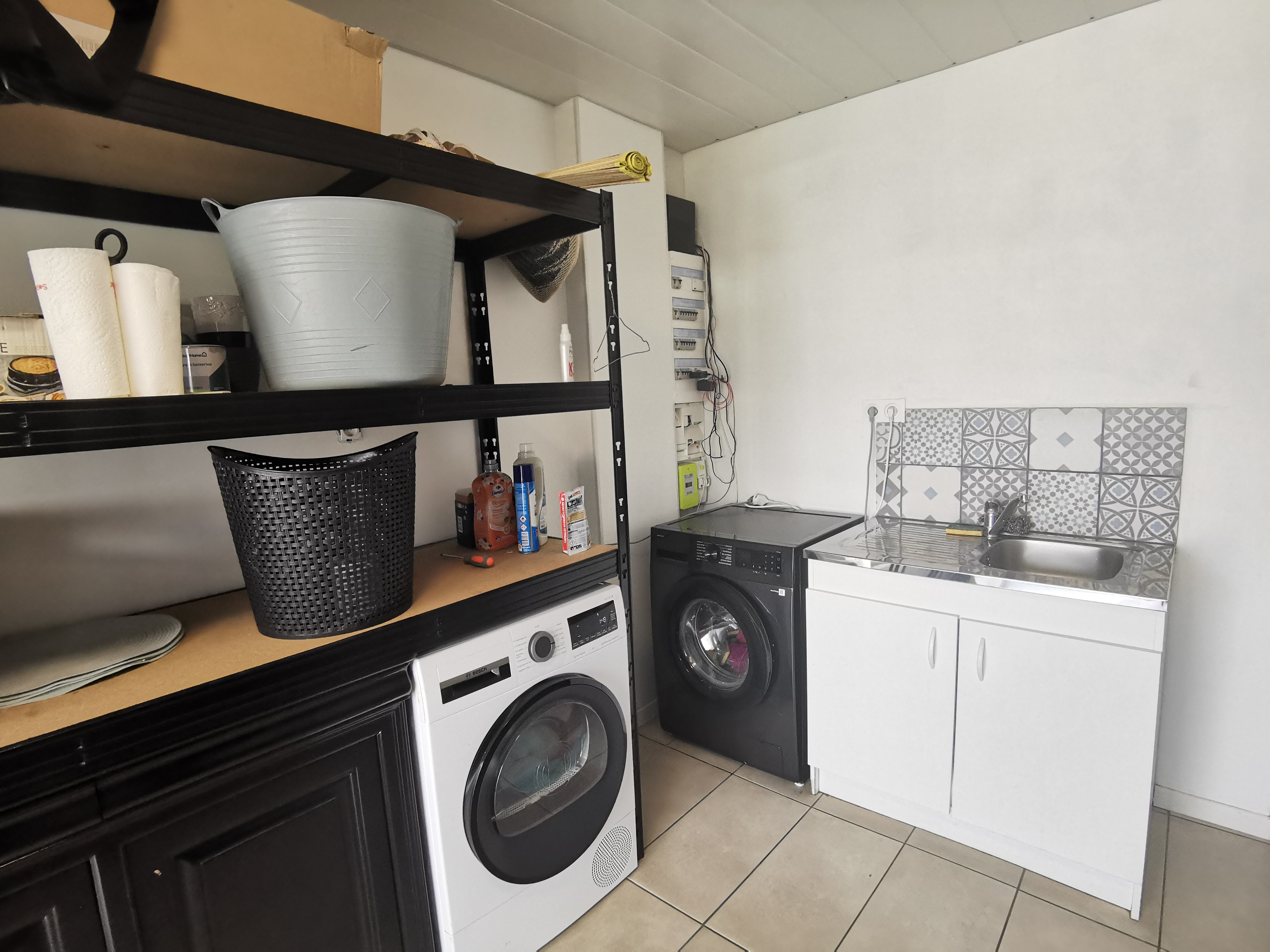 Storage room with washing machine and tumble dryer