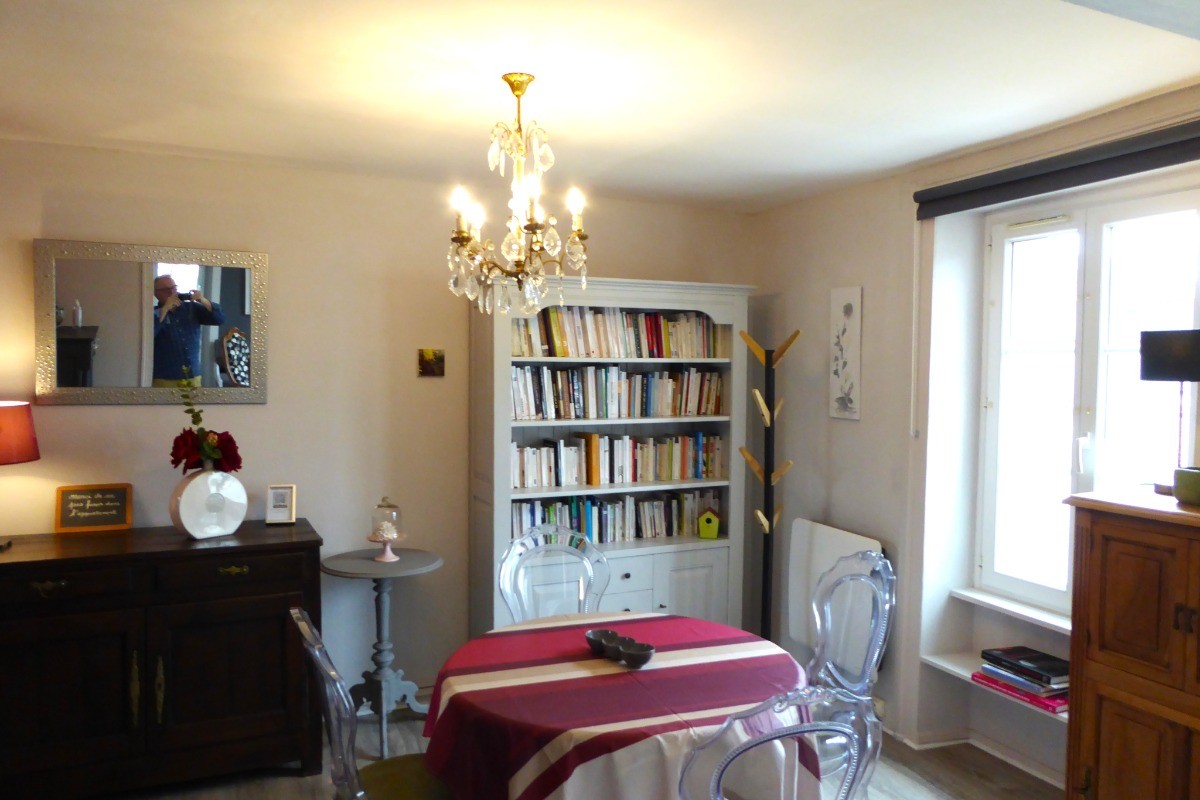Living area with library. Separate kitchen to the left.