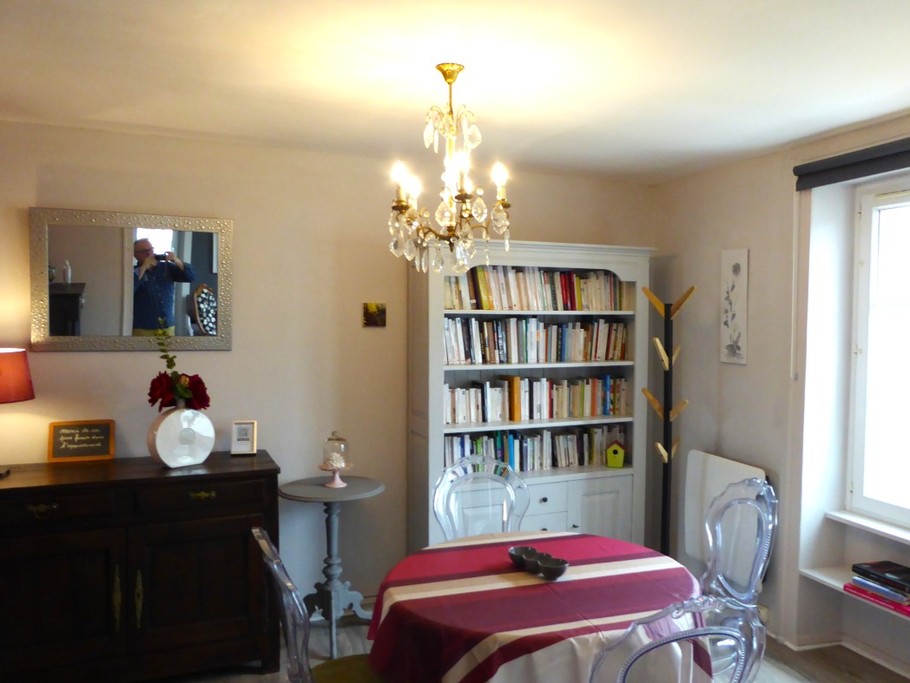 Living area with library. Separate kitchen to the left.