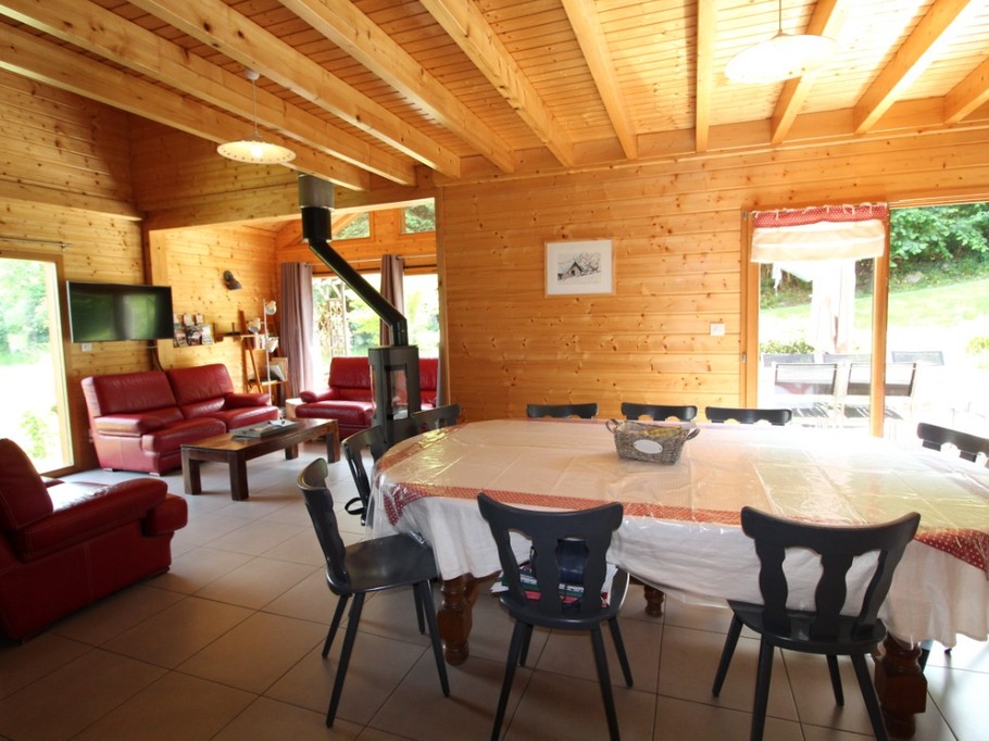 Salon/ séjour  - Large table pouvant accueillir 10 adultes à 2 chaises hautes pour enfants. Porte fenêtre sur terrasse extérieure.