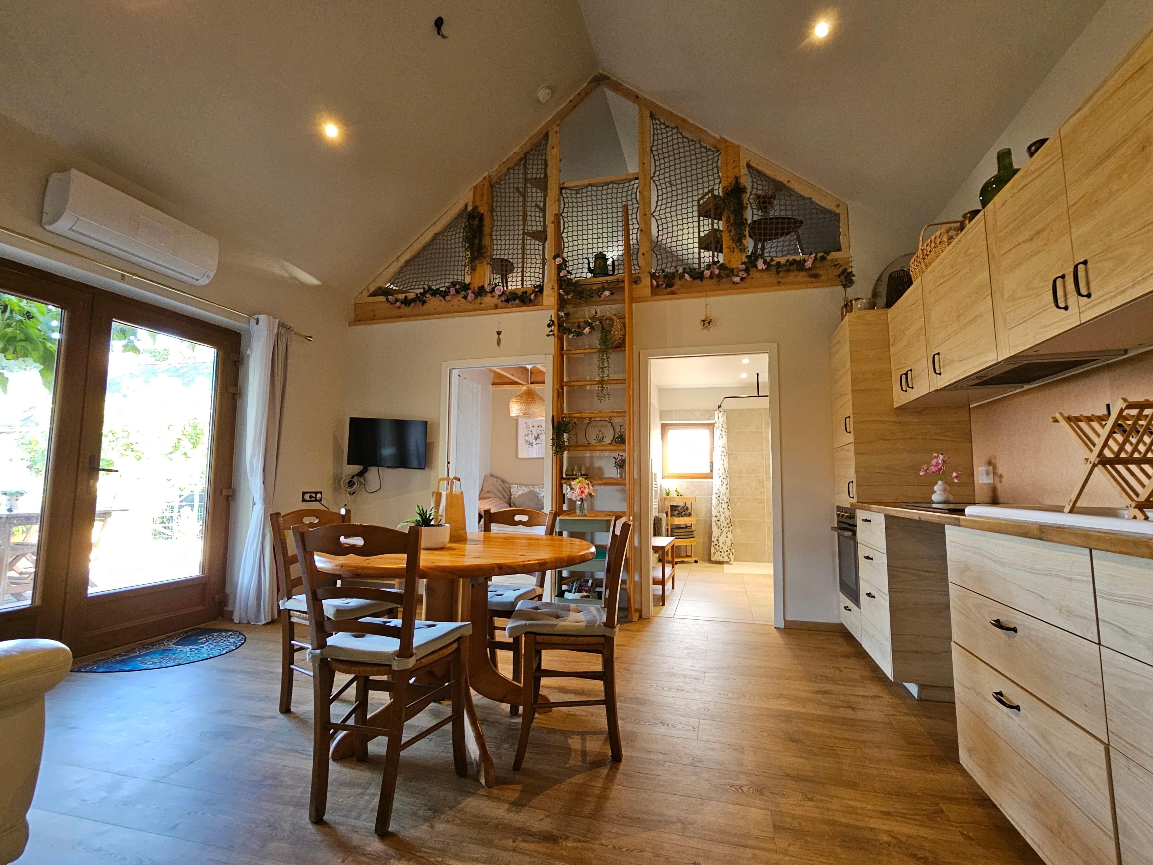 Open-plan living area with a fitted kitchen, lounge and dining table.