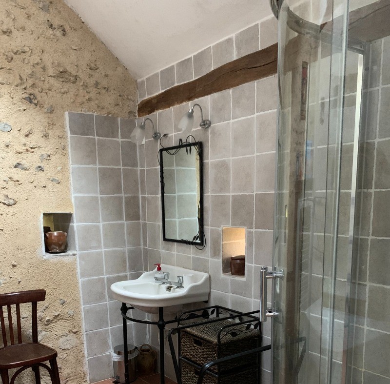 Salle d'eau spacieuse au rez-de-chaussée avec douche grande dimension. WC séparé à proximité.