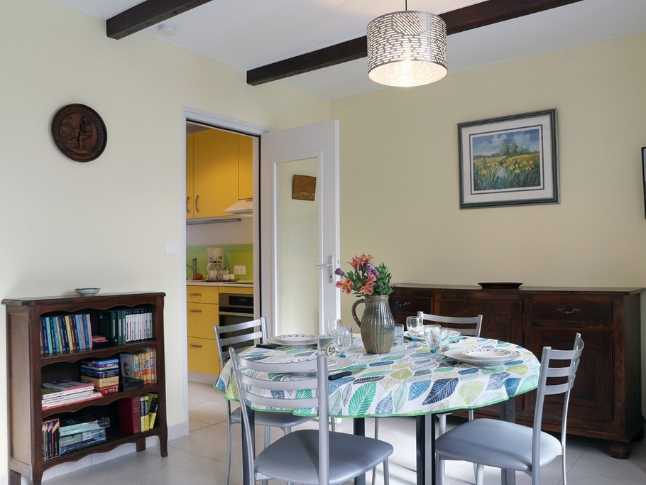 Bright living room with round table seating 4. Opening onto the garden