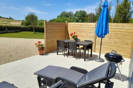 Terrace with table, chairs, parasol, sun loungers, barbecue