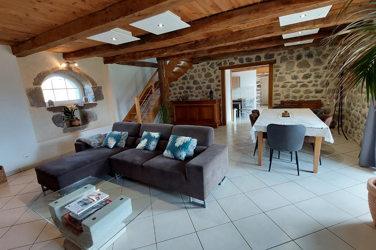 Large stone living room with exposed beams Cantal