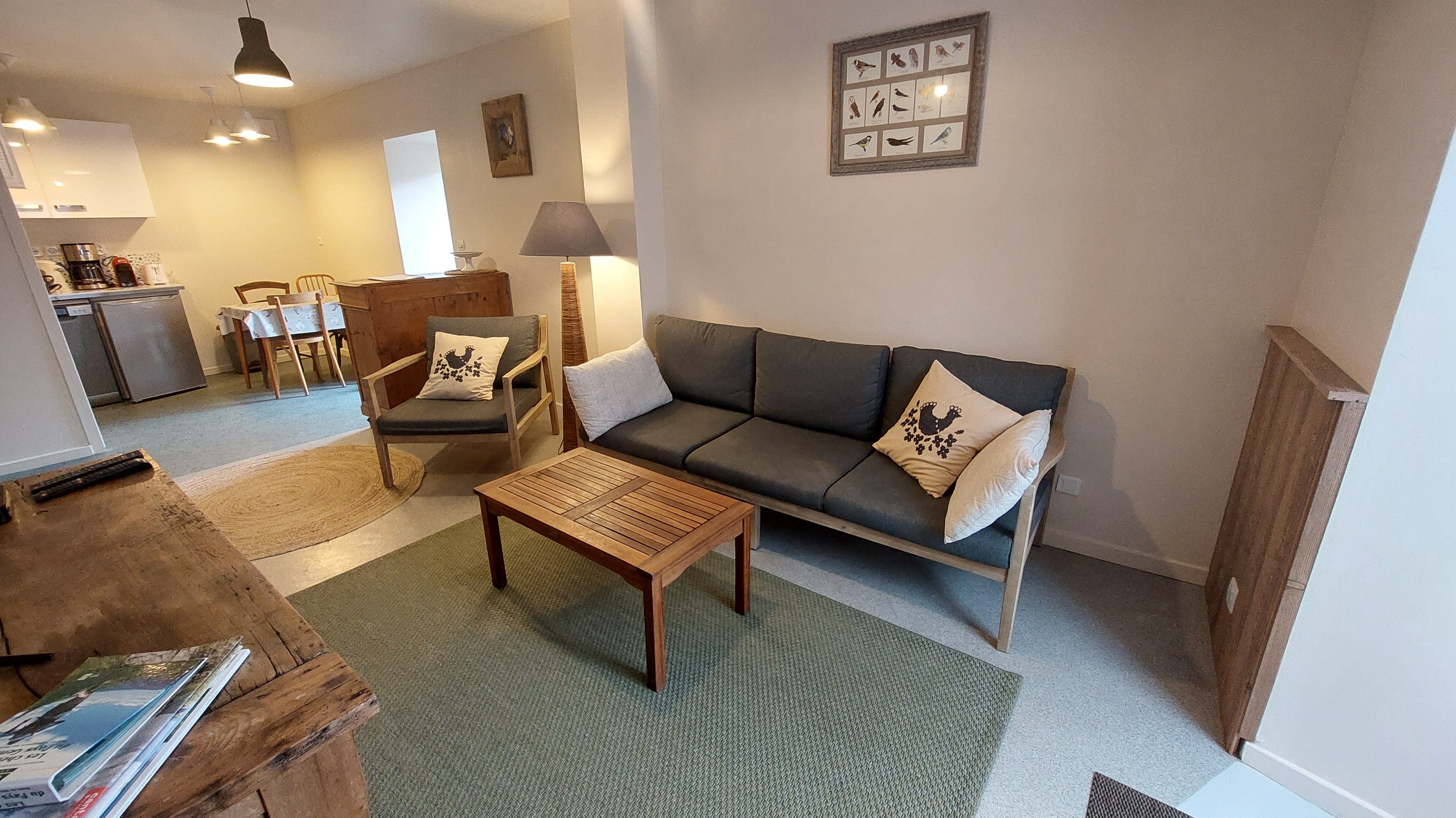 Gîte living room with lounge and fitted kitchen at Le Claux