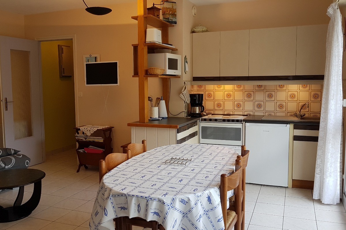 L'espace repas et la cuisine dans la pièce de vie - Appartement "Le Beaulieu"