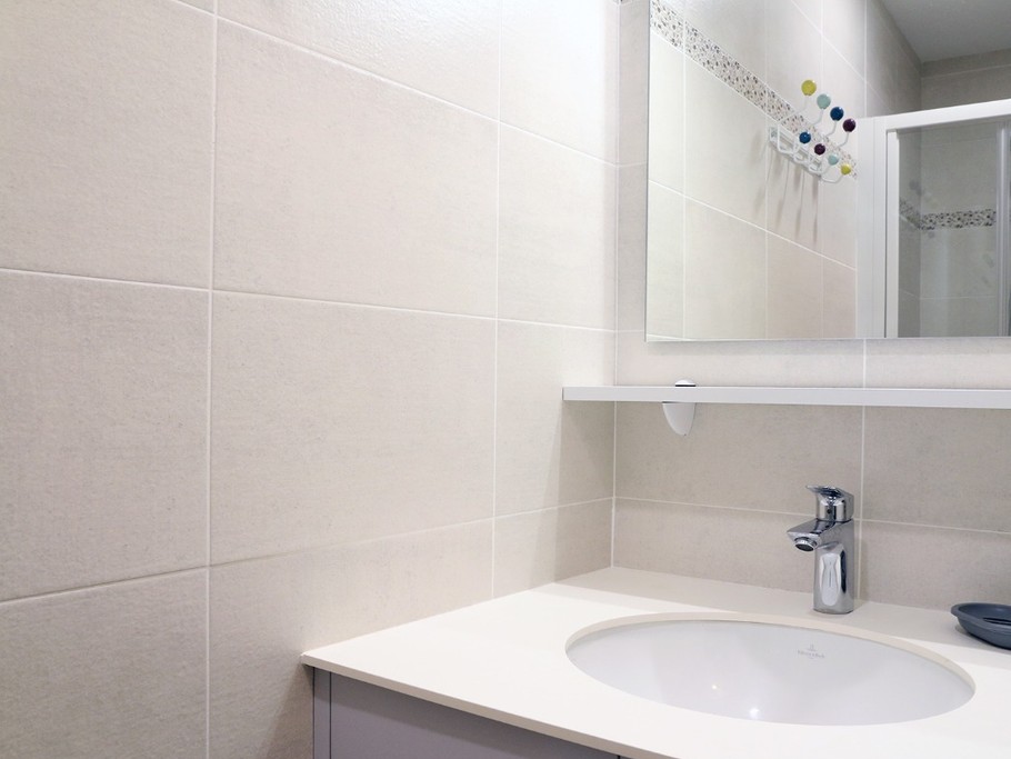 Bathroom with shower and vanity unit
