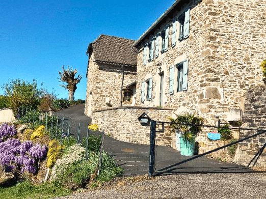 A stone façade typical of the Cantal region, a village house in Lapeyrugue