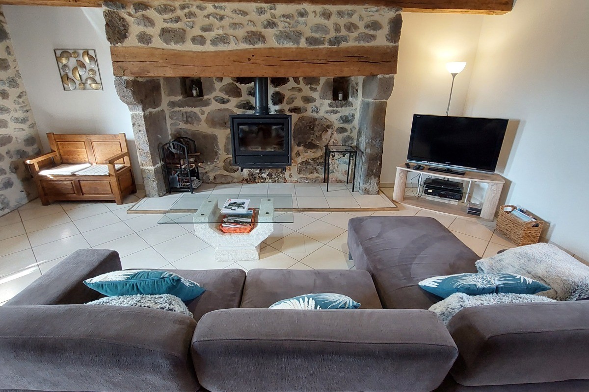 Living room with fireplace in renovated Auvergne house